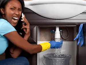 Emergency plumbing repair for a leaking sink drain under a bathroom vanity in Hartford, CT